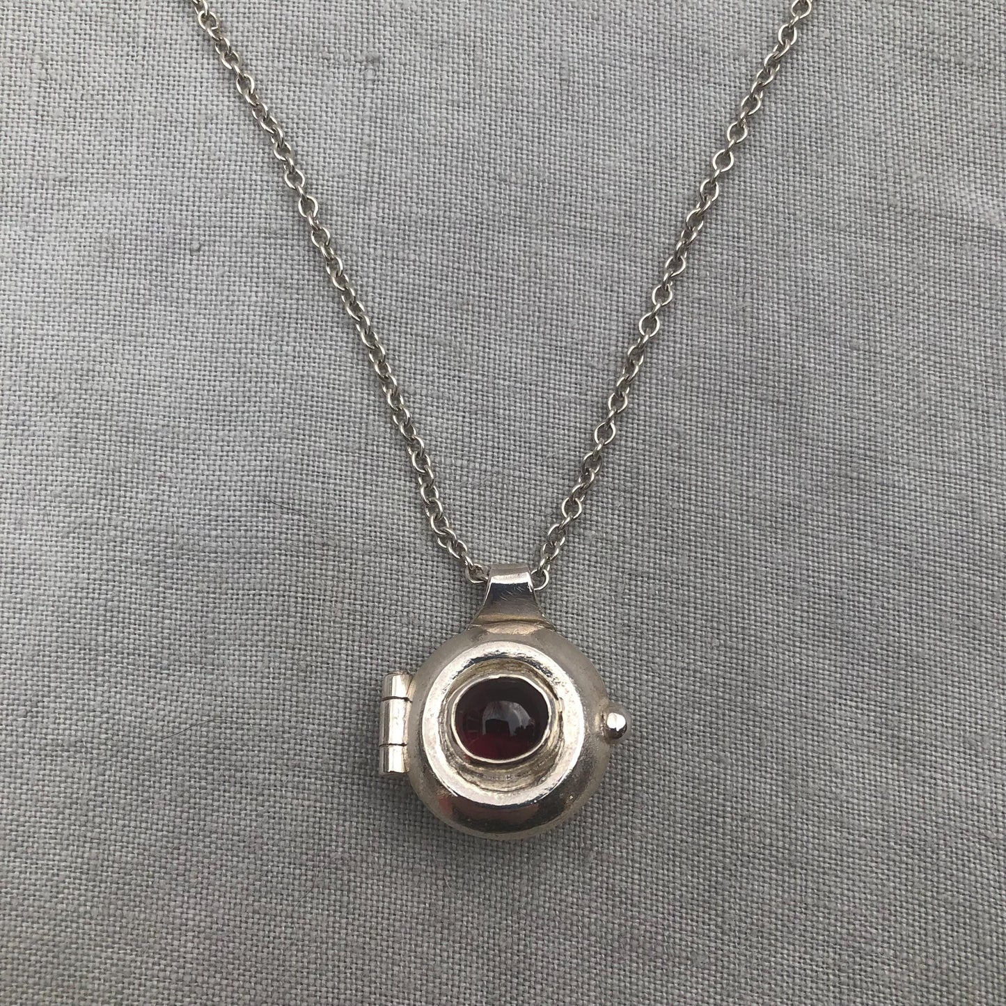 Garnet locket in argentium sterling silver // Porthole locket