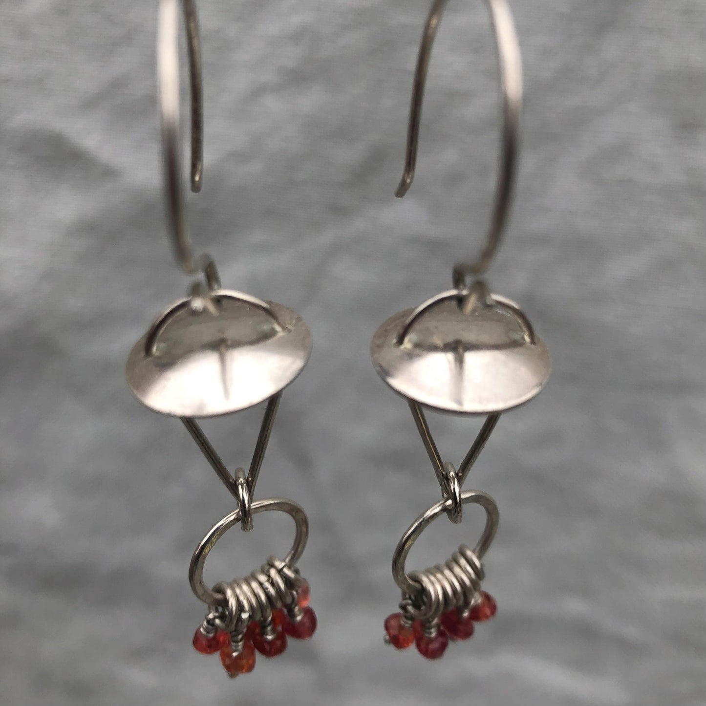 Red-orange sapphire kinetic chandelier earrings in argentium sterling silver