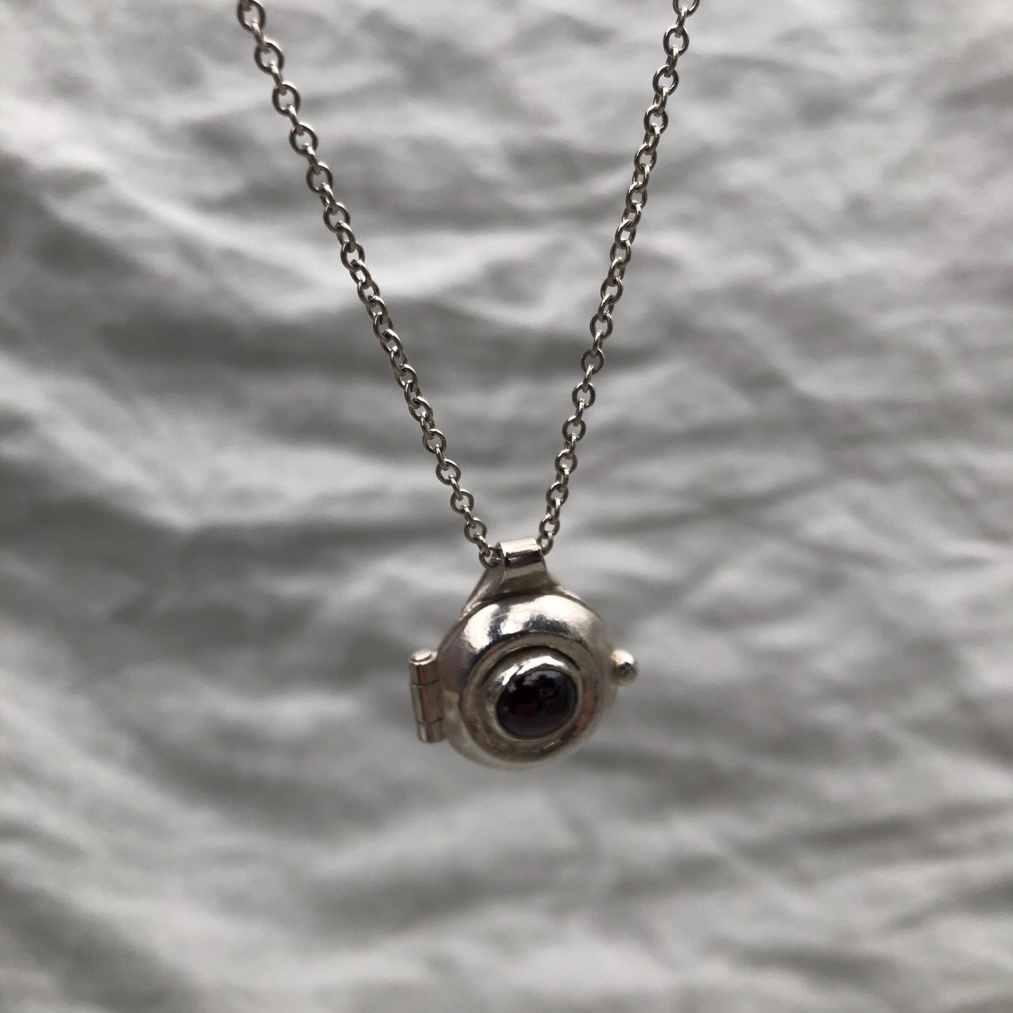 Garnet locket in argentium sterling silver // Porthole locket
