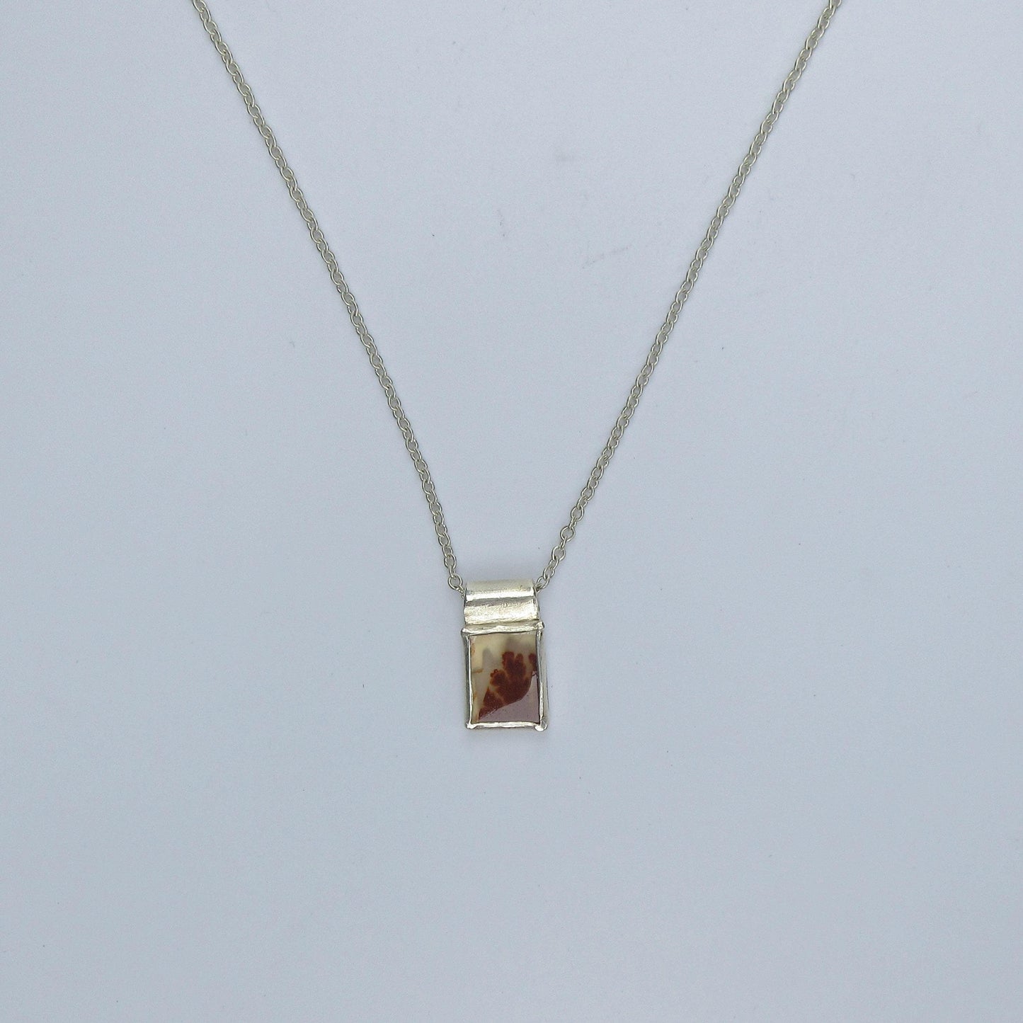 Dendritic agate pendant in argentium sterling silver // Red picture agate with open back