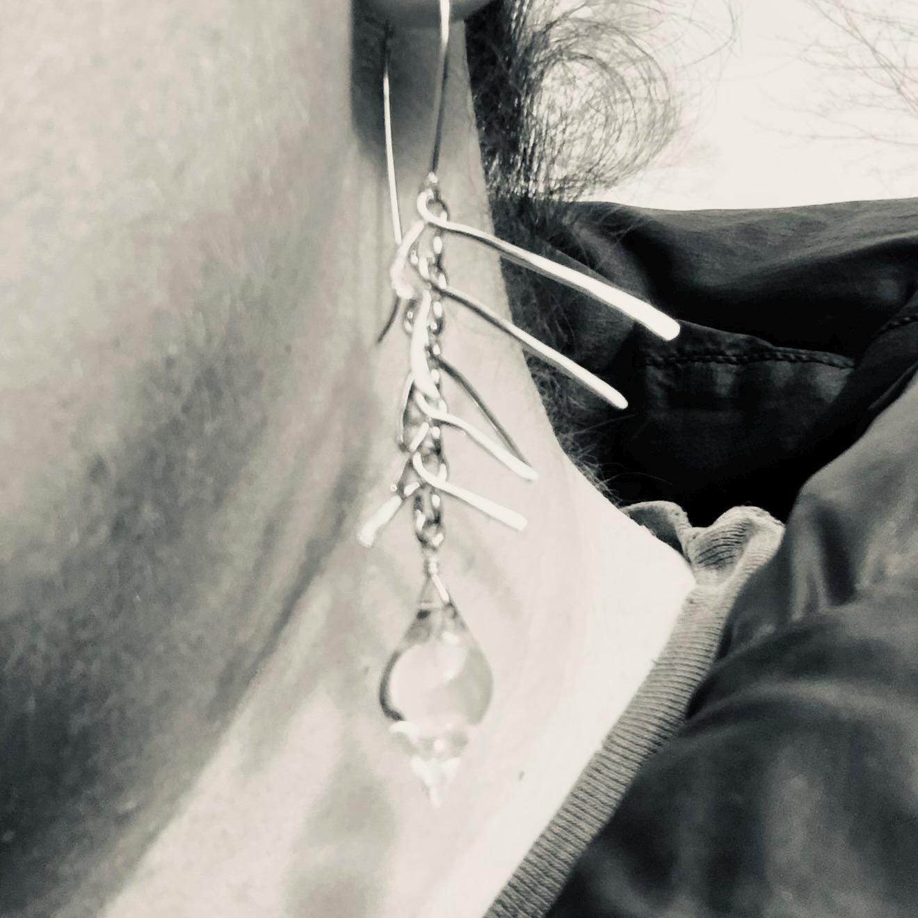Kinetic sculptural earrings in hammered argentium sterling silver with clear quartz // Fishbone statement earrings with natural rock crystal