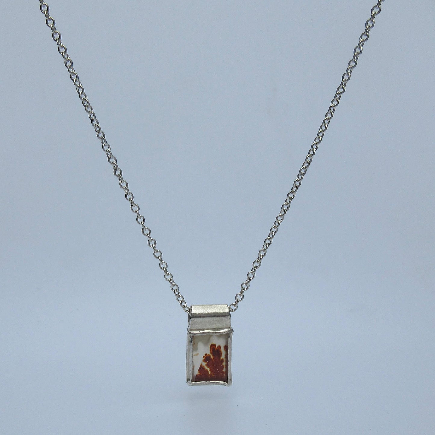 Dendritic agate pendant in argentium sterling silver // Red picture agate with open back