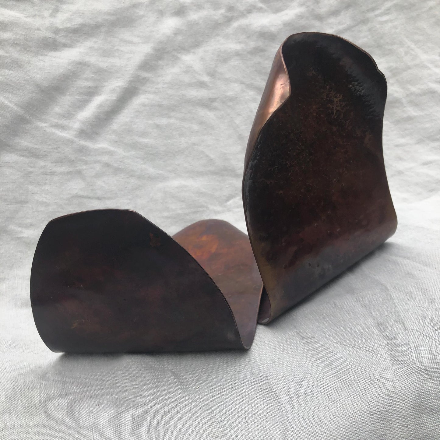 Hammered copper bookends with warm copper patina