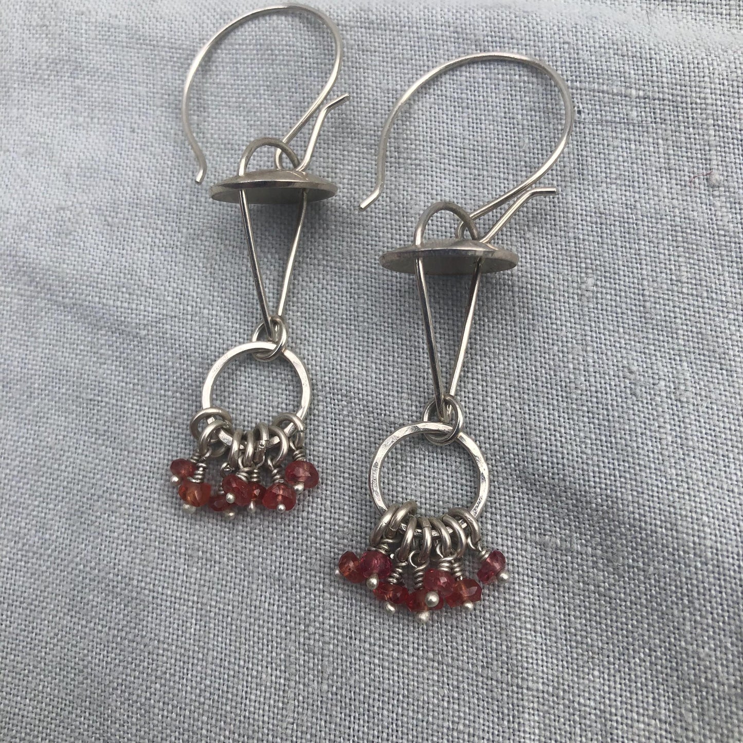 Red-orange sapphire kinetic chandelier earrings in argentium sterling silver