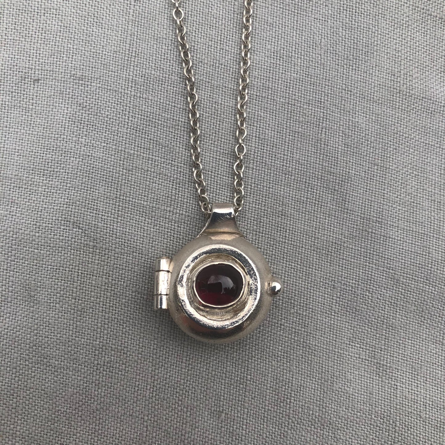 Garnet locket in argentium sterling silver // Porthole locket