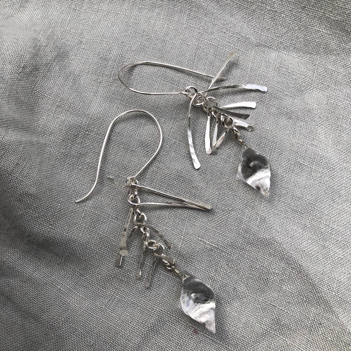 Kinetic sculptural earrings in hammered argentium sterling silver with clear quartz // Fishbone statement earrings with natural rock crystal