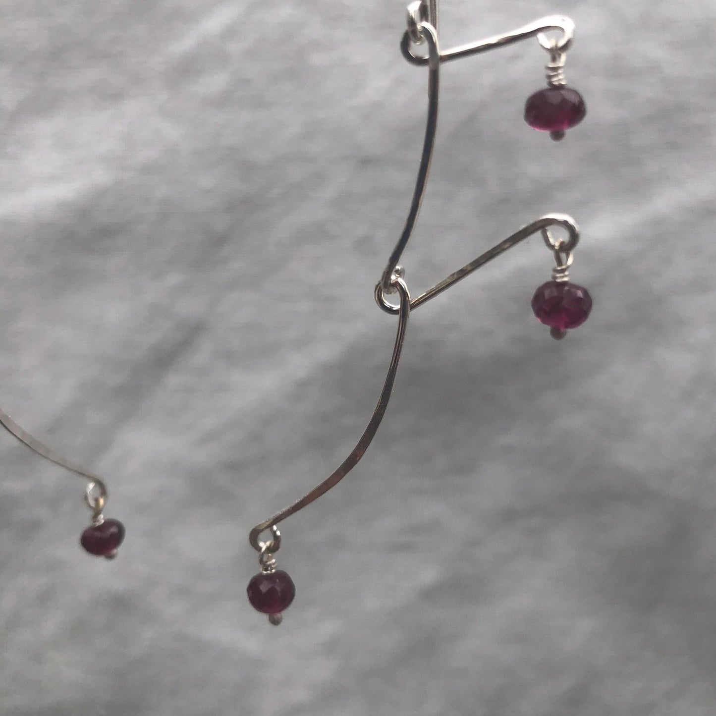 Kinetic sculptural garnet earrings in argentium sterling silver // Rhodolite garnet Calder earrings