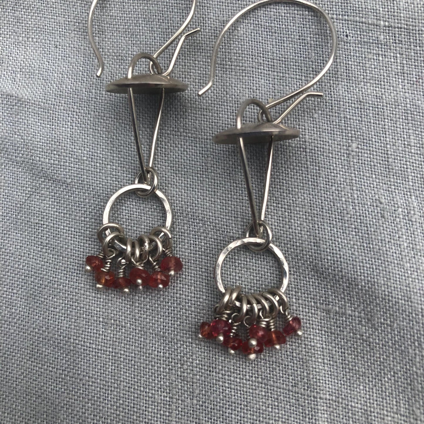 Red-orange sapphire kinetic chandelier earrings in argentium sterling silver