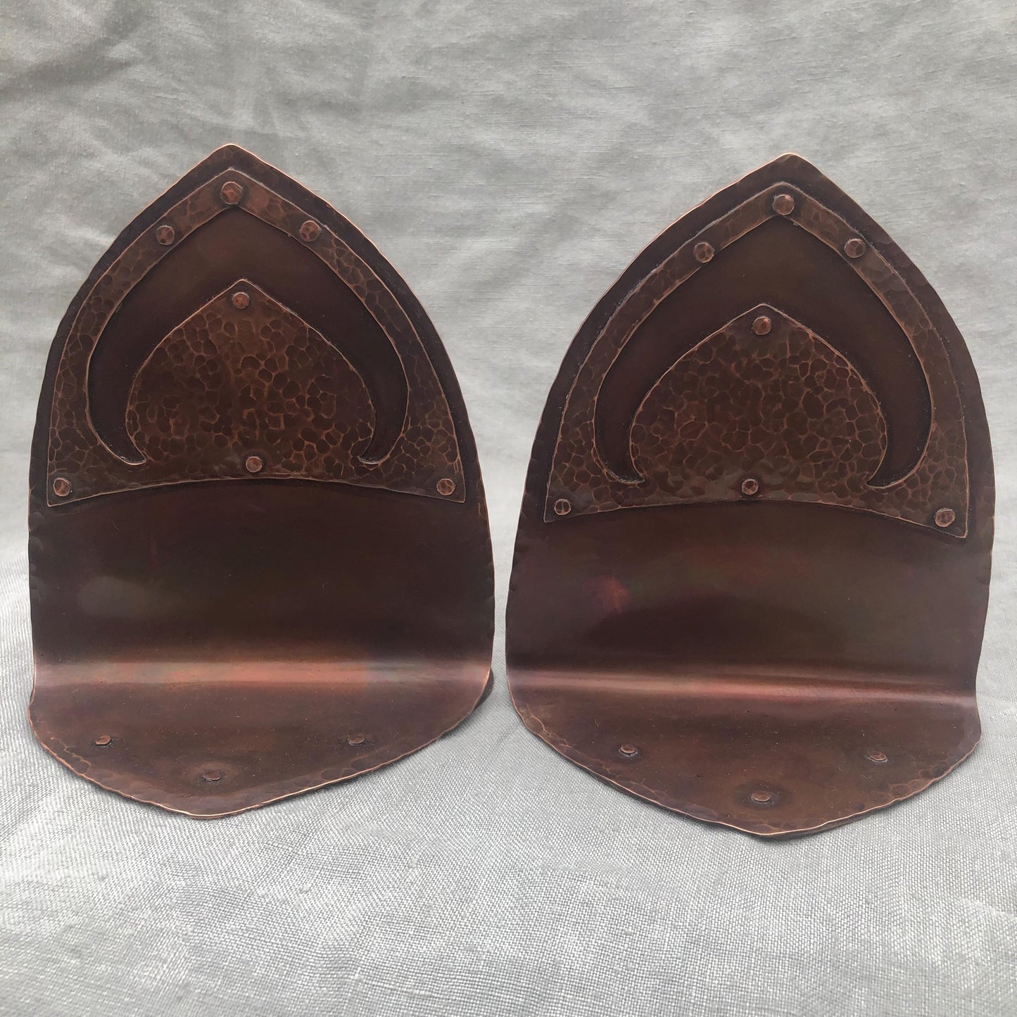 Riveted hammered copper bookends with warm copper patina