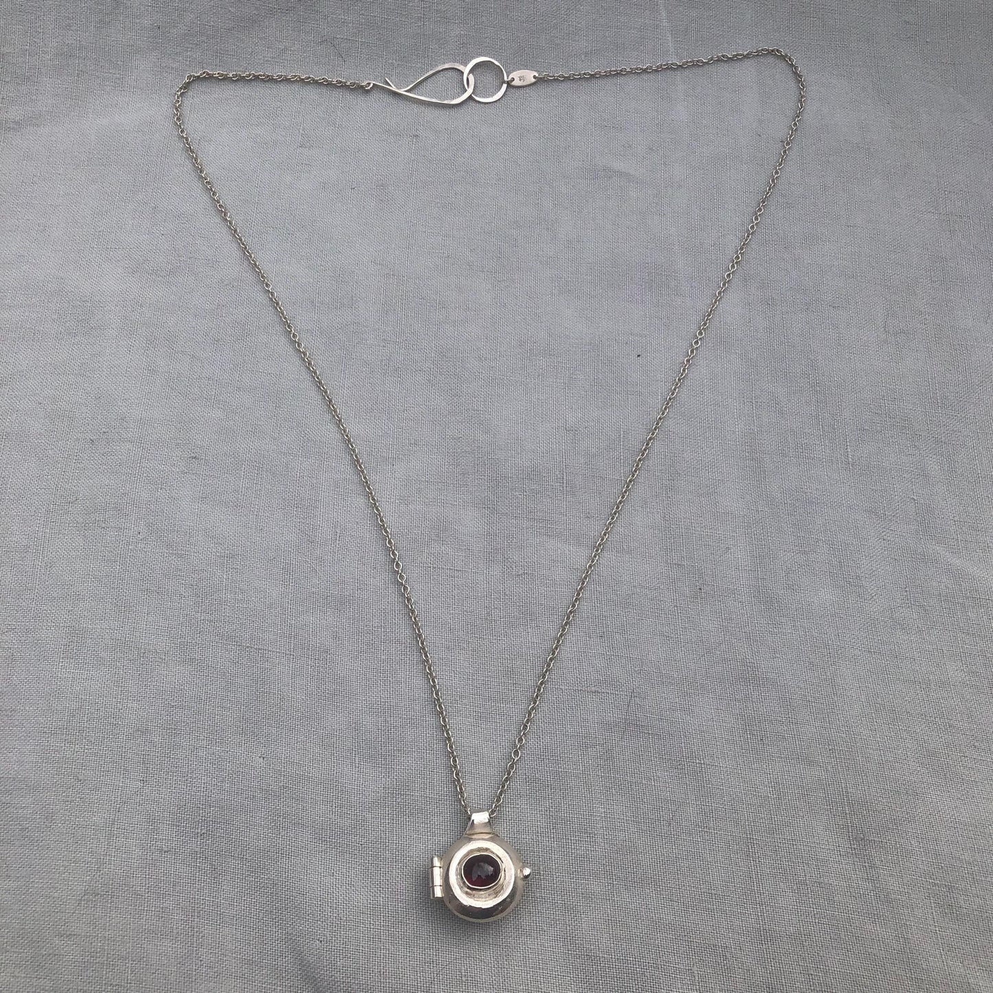 Garnet locket in argentium sterling silver // Porthole locket