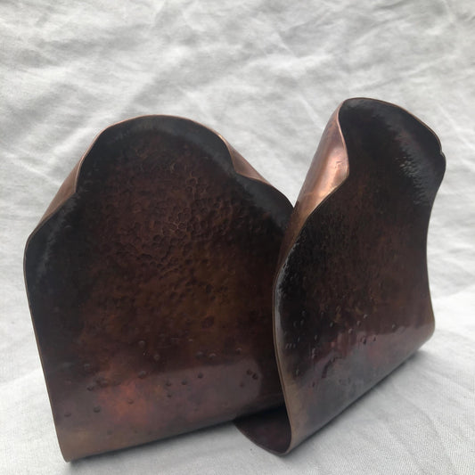 Hammered copper bookends with warm copper patina
