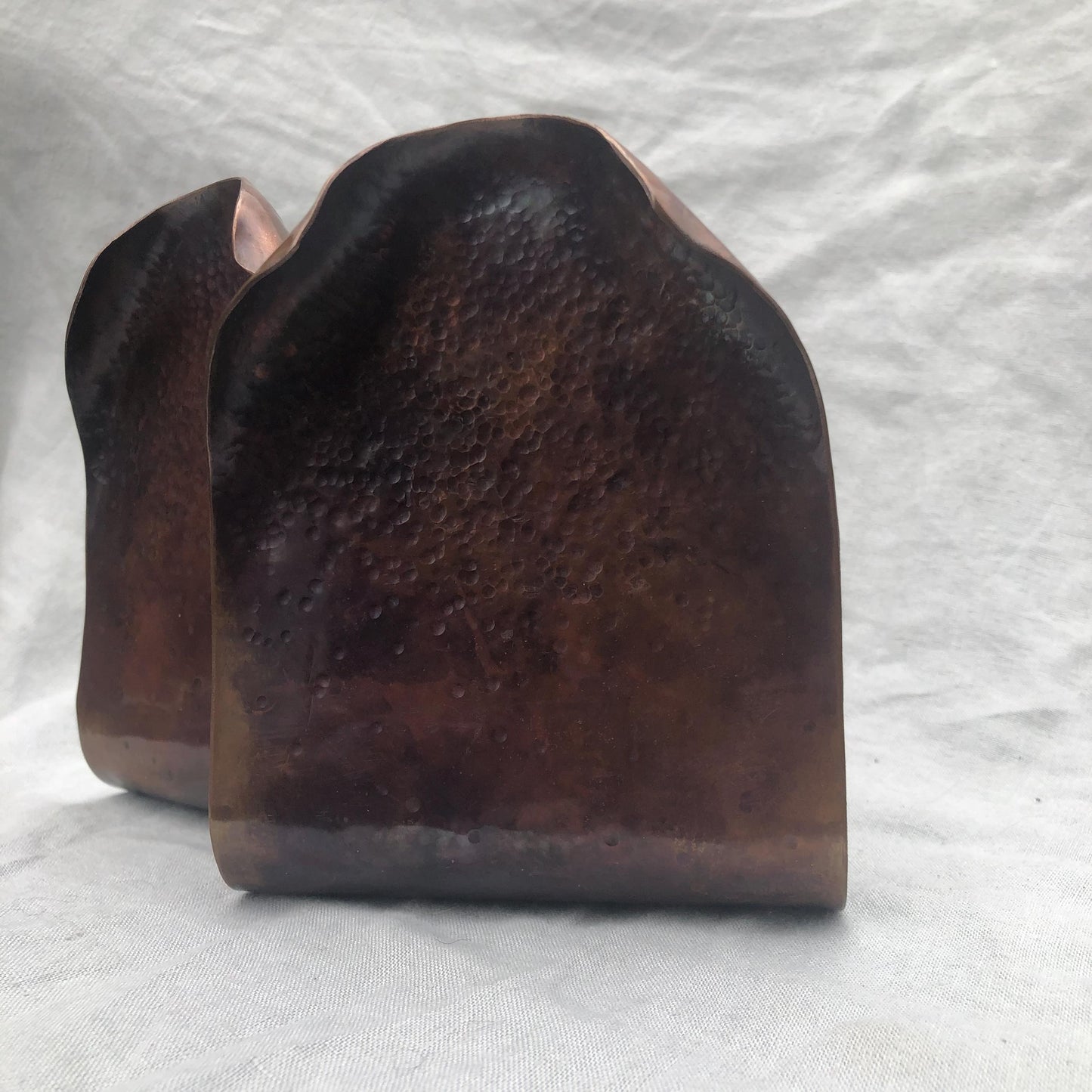 Hammered copper bookends with warm copper patina