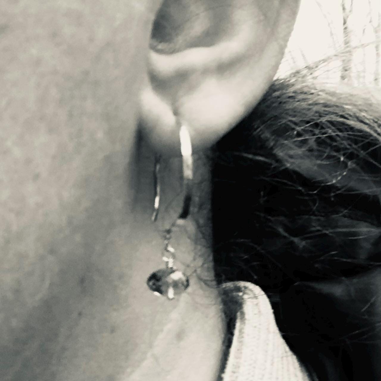Solid gold hoop earrings with faceted peridot drops