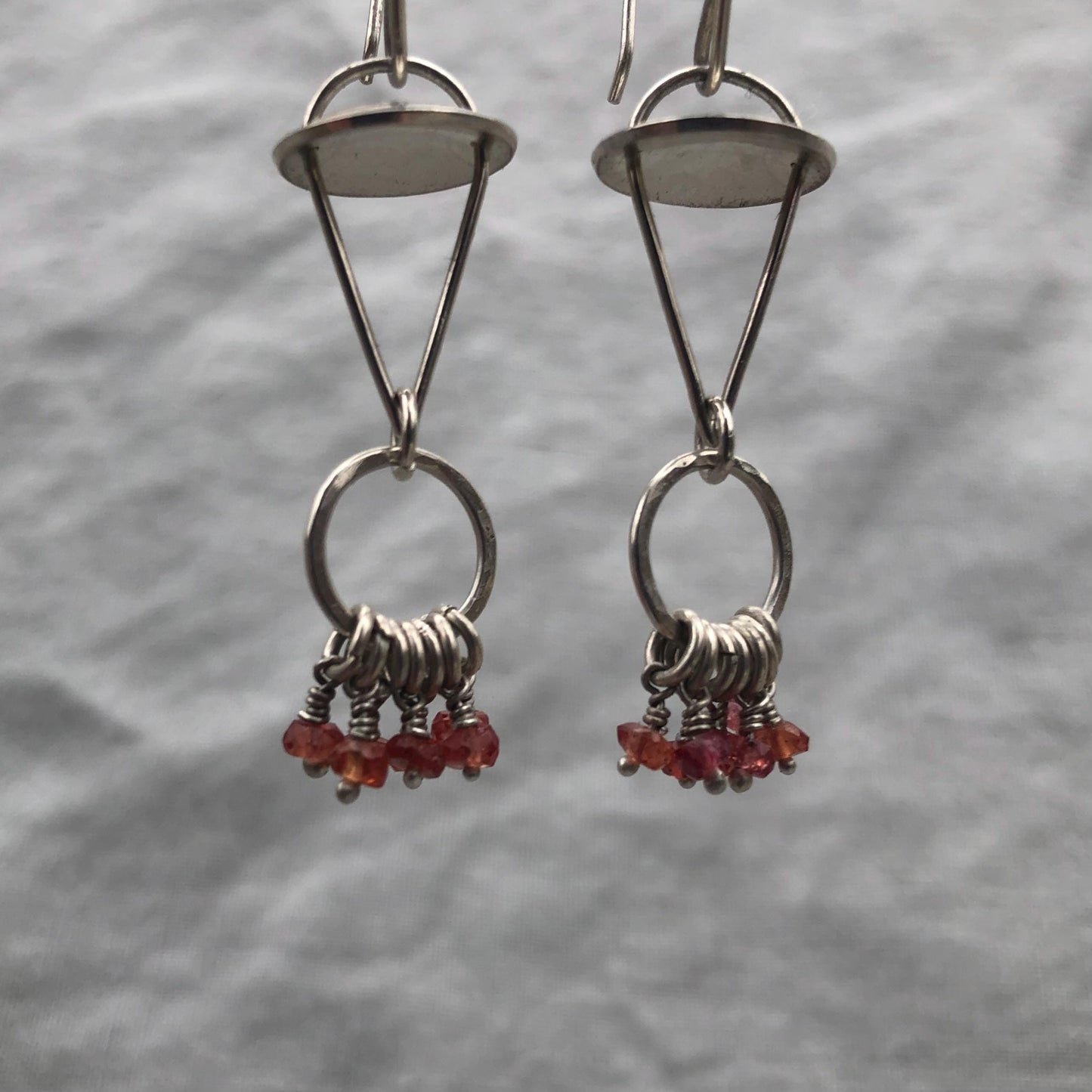 Red-orange sapphire kinetic chandelier earrings in argentium sterling silver