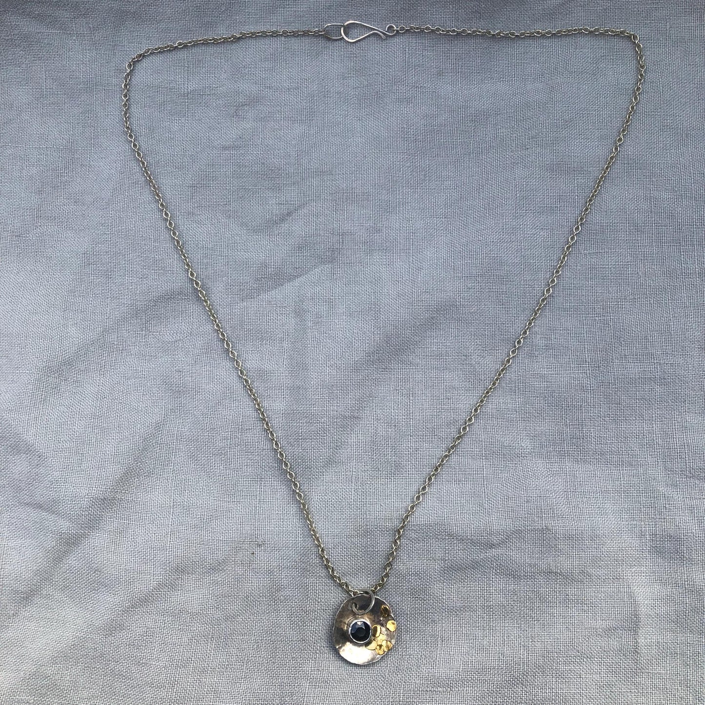 Natural earth-mined sapphire pendant in argentium silver and 24 karat gold