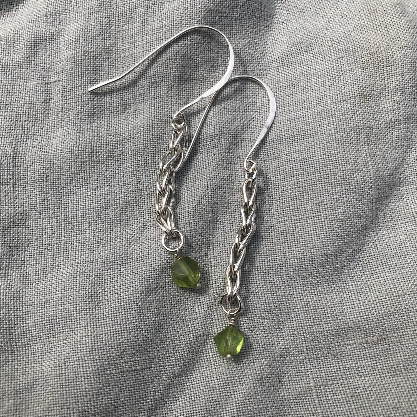 Loop-in-loop earrings in argentium sterling silver with geometric apple-green Arizona peridot