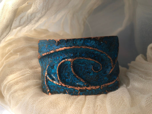 Wave cuff in repoussé and chased copper with blue patina