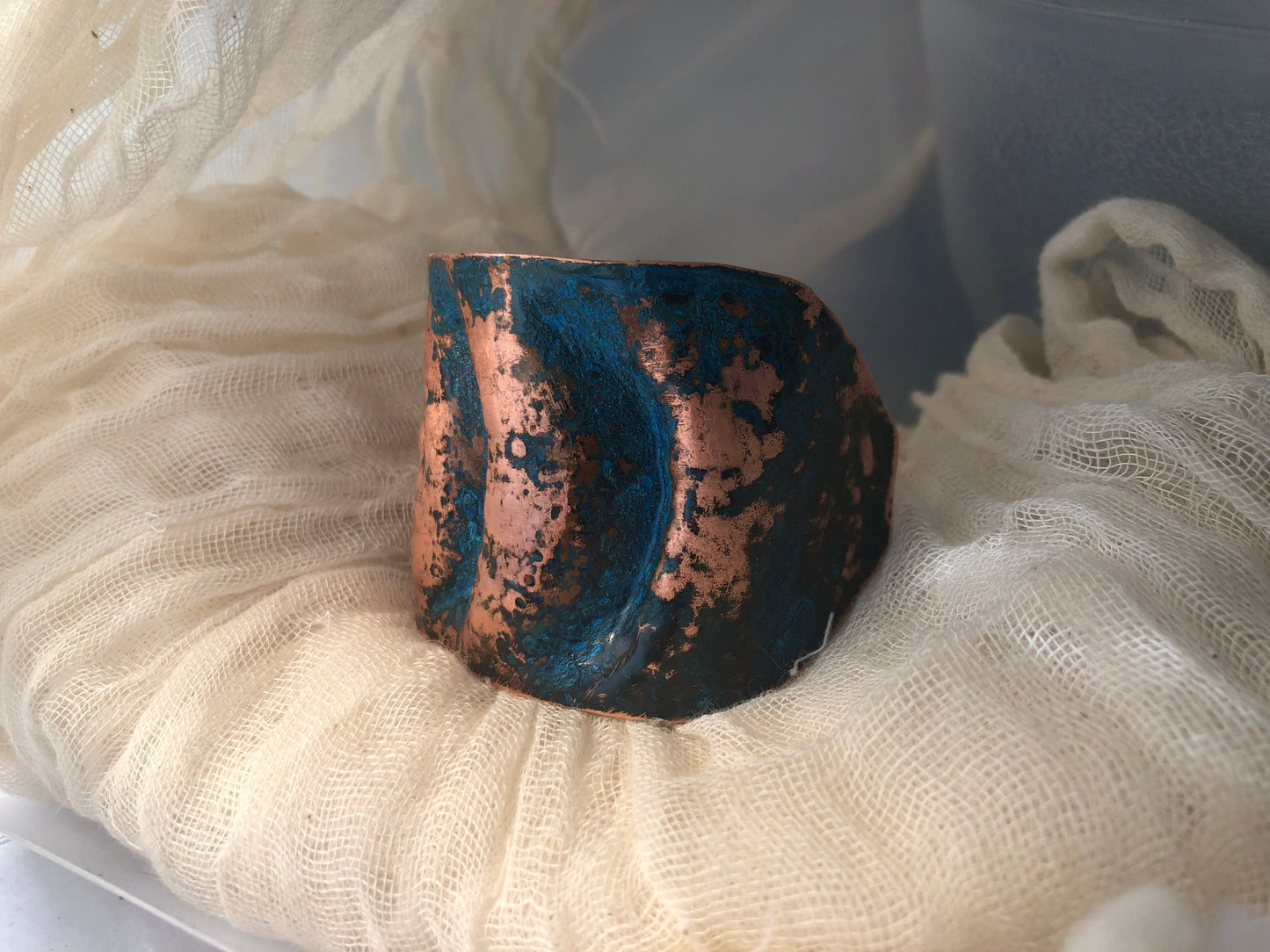 Eye cuff in chased and repoussé copper with blue patina