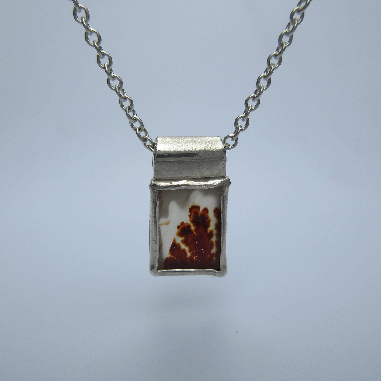 Rectangular red dendritic agate pendant in argentium sterling silver