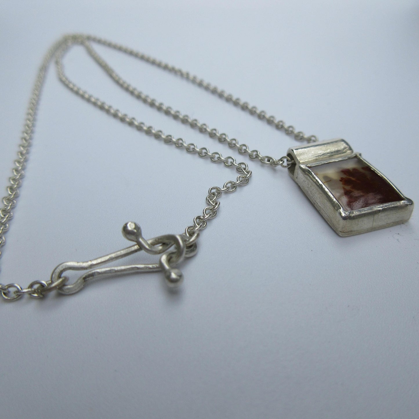 Rectangular red dendritic agate pendant in argentium sterling silver