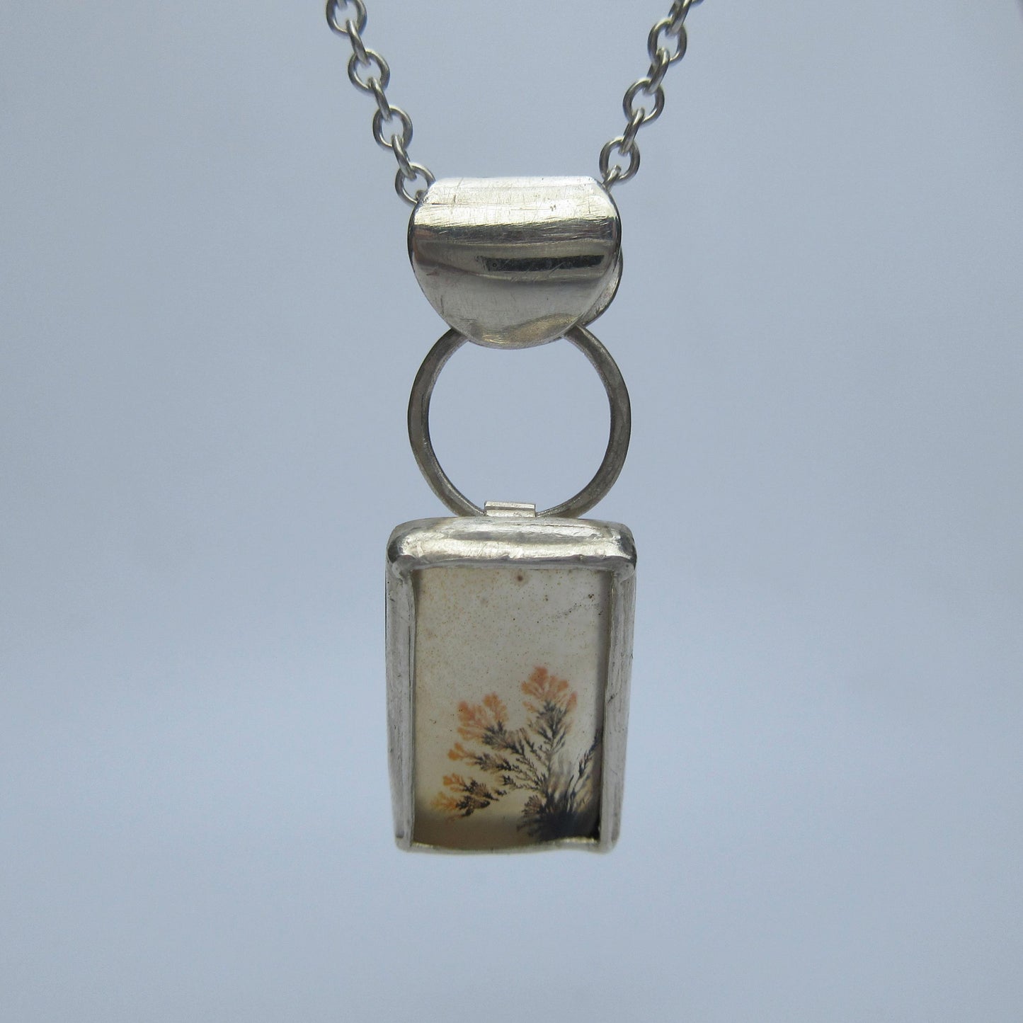 Disappearing dendritic agate pendant in argentium sterling silver