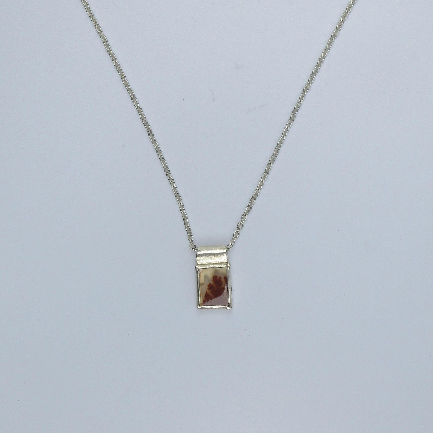 Rectangular red dendritic agate pendant in argentium sterling silver