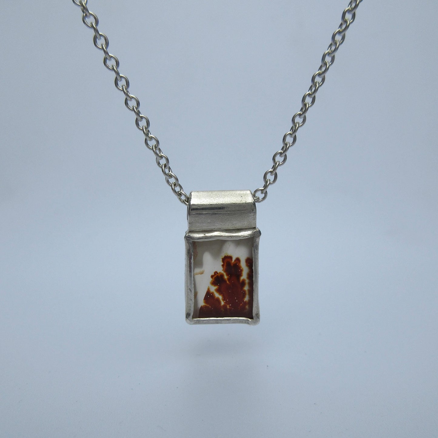 Rectangular red dendritic agate pendant in argentium sterling silver