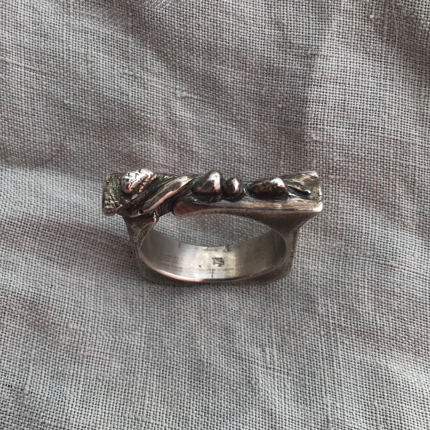 Snake on a rock wall ring in argentium sterling silver // U.S. size 11