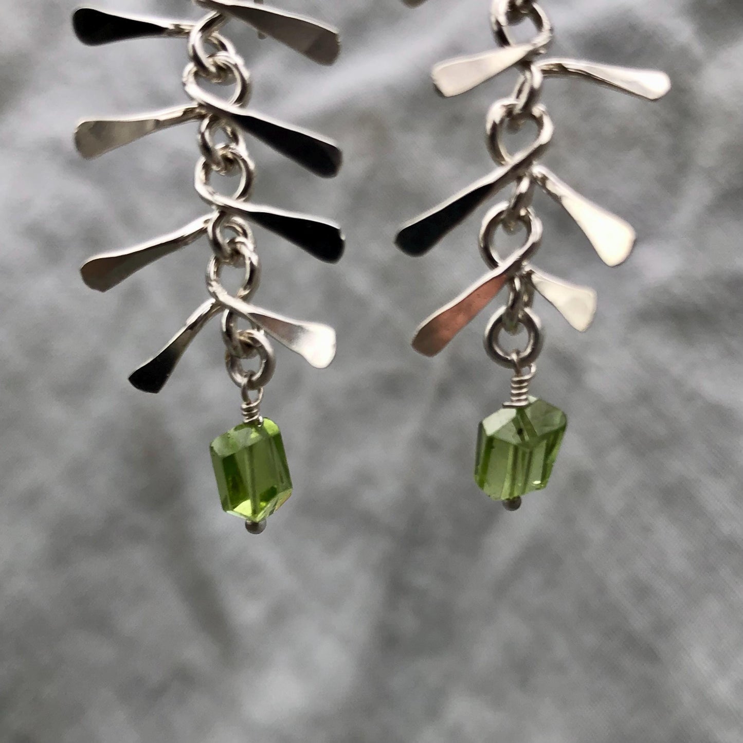 Ribcage earrings in argentium sterling silver with asymmetrical Arizona peridot // Kinetic sculptural earrings