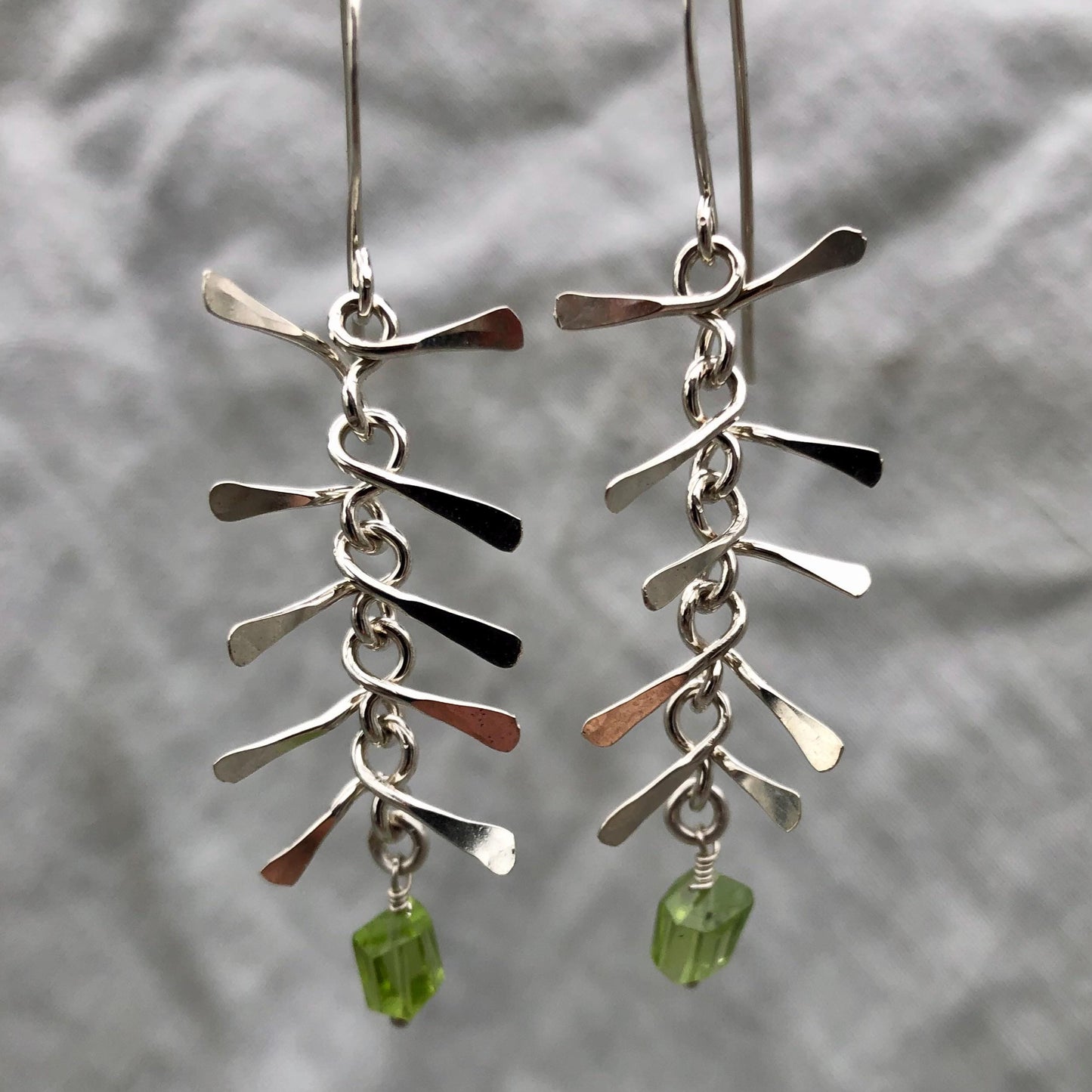 Ribcage earrings in argentium sterling silver with asymmetrical Arizona peridot // Kinetic sculptural earrings