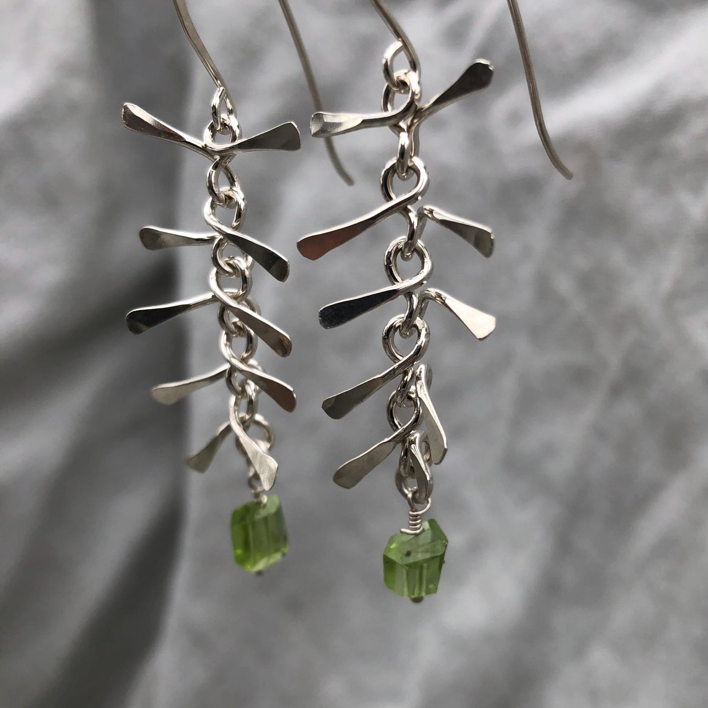 Ribcage earrings in argentium sterling silver with asymmetrical Arizona peridot // Kinetic sculptural earrings