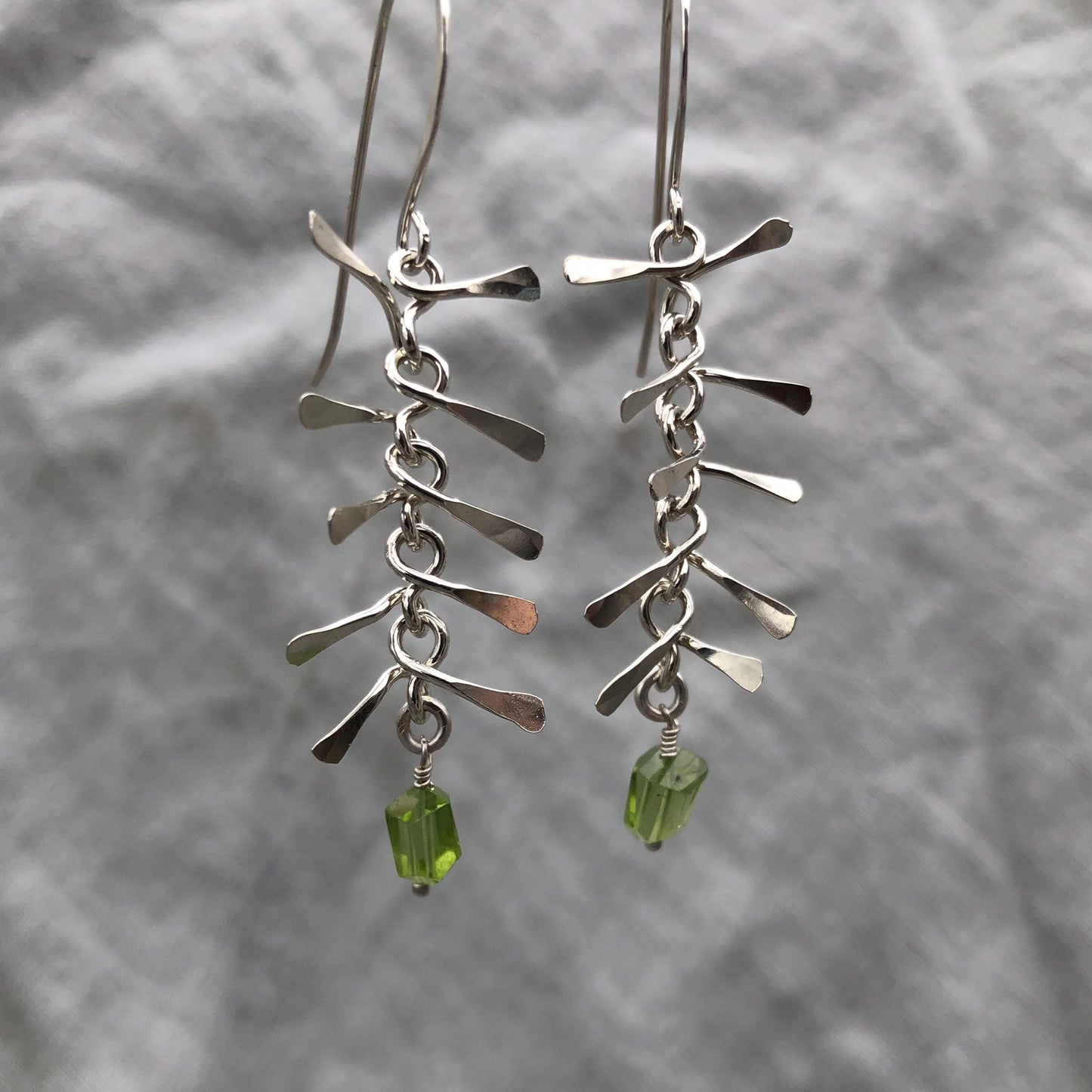 Ribcage earrings in argentium sterling silver with asymmetrical Arizona peridot // Kinetic sculptural earrings