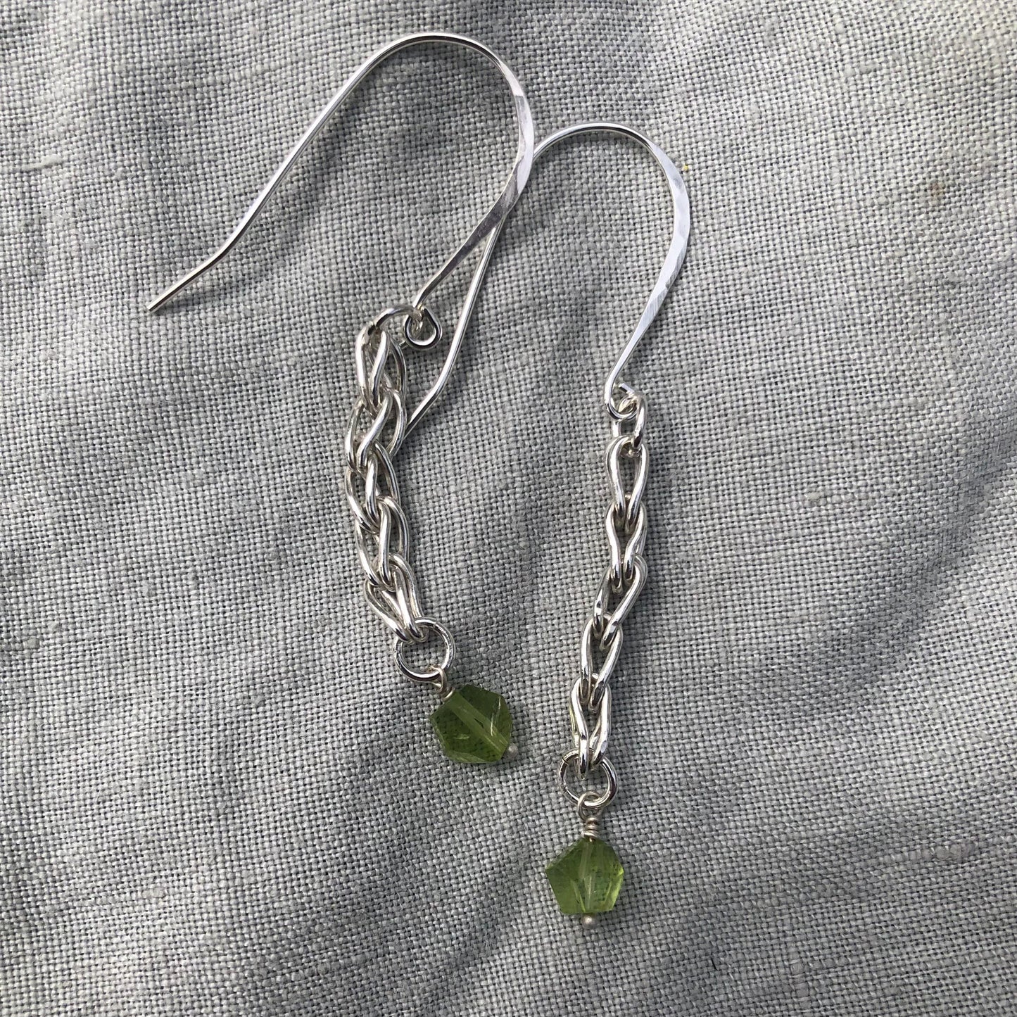 Loop-in-loop earrings in argentium sterling silver with geometric apple-green Arizona peridot