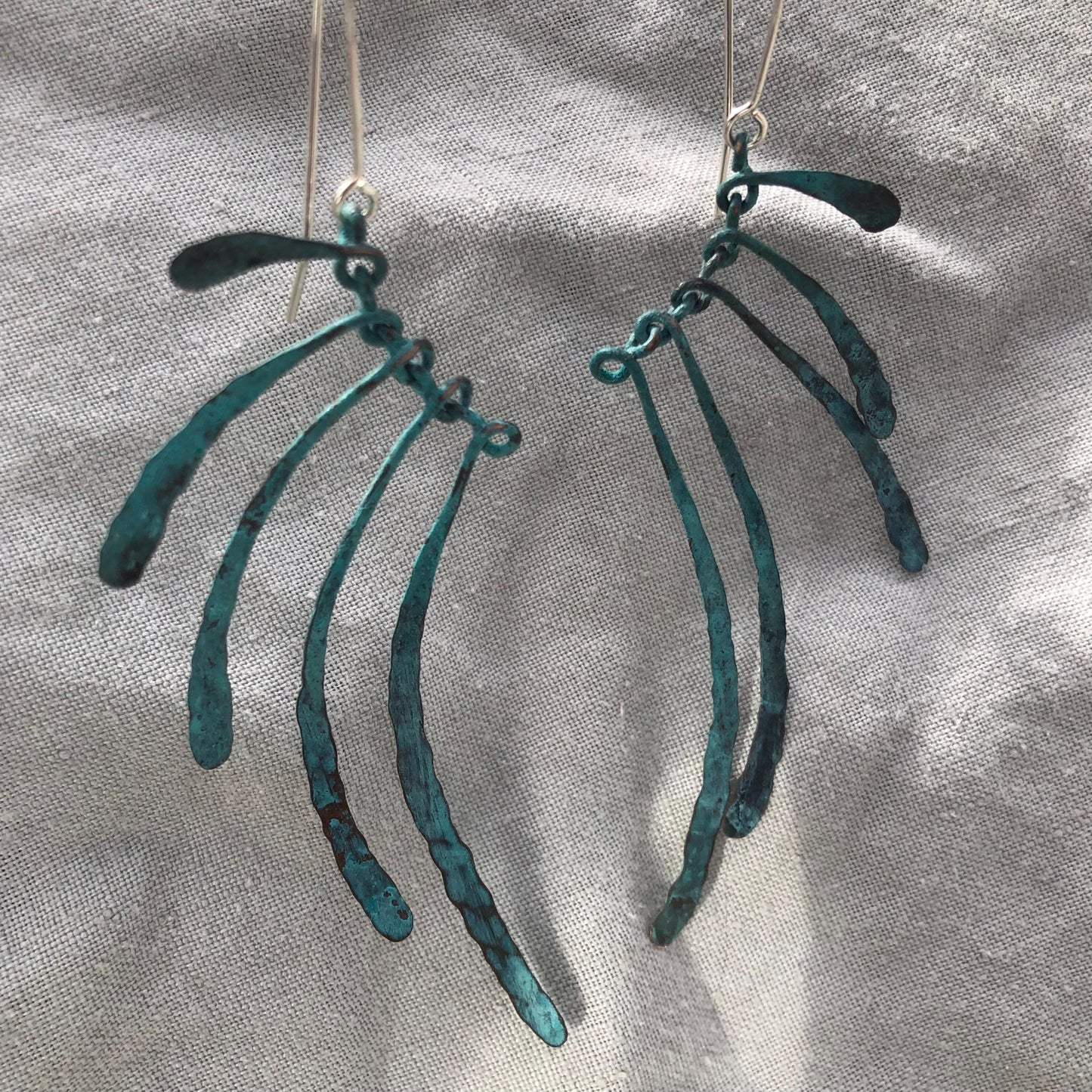 Bare bones earrings in copper with blue-green verdigris patina