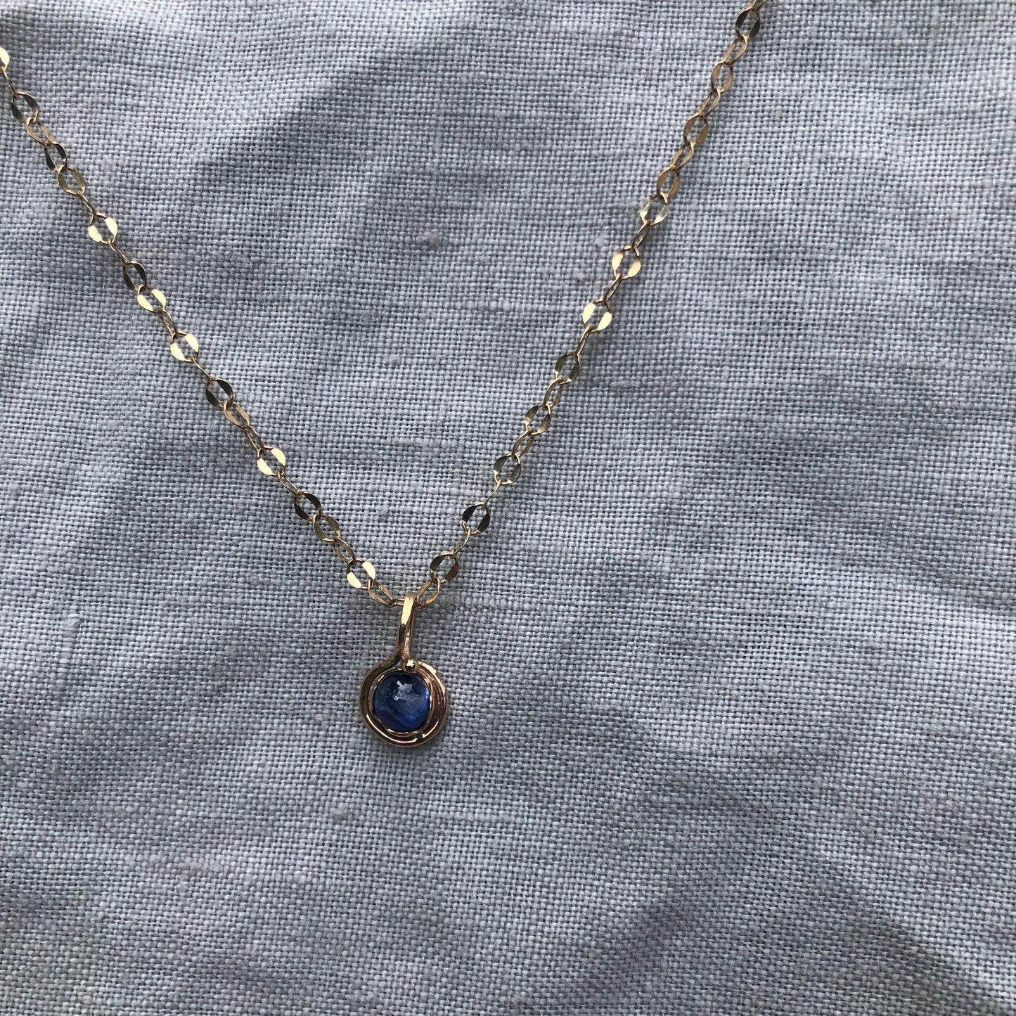 Natural blue sapphire cabochon pendant in solid 14 karat gold