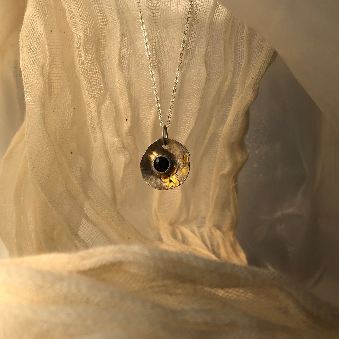 Dark blue natural sapphire "Solar Eclipse" pendant in argentium silver and 24 karat gold, artisan made sapphire pendant