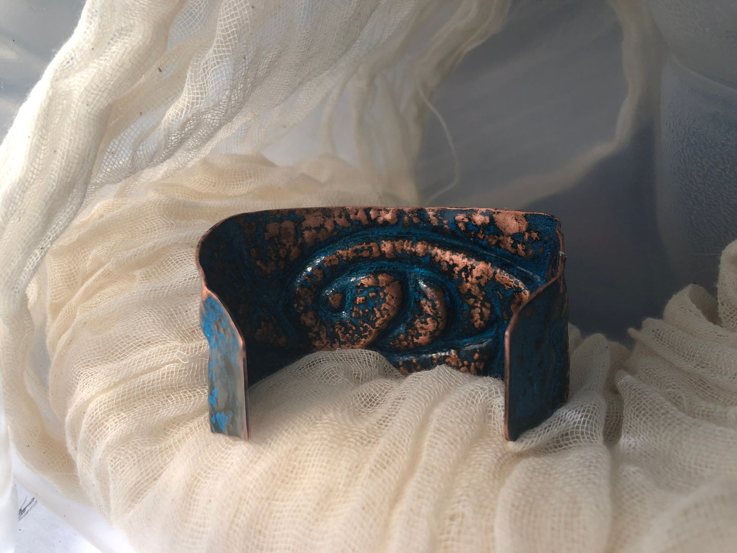 Wave cuff in repoussé and chased copper with blue patina